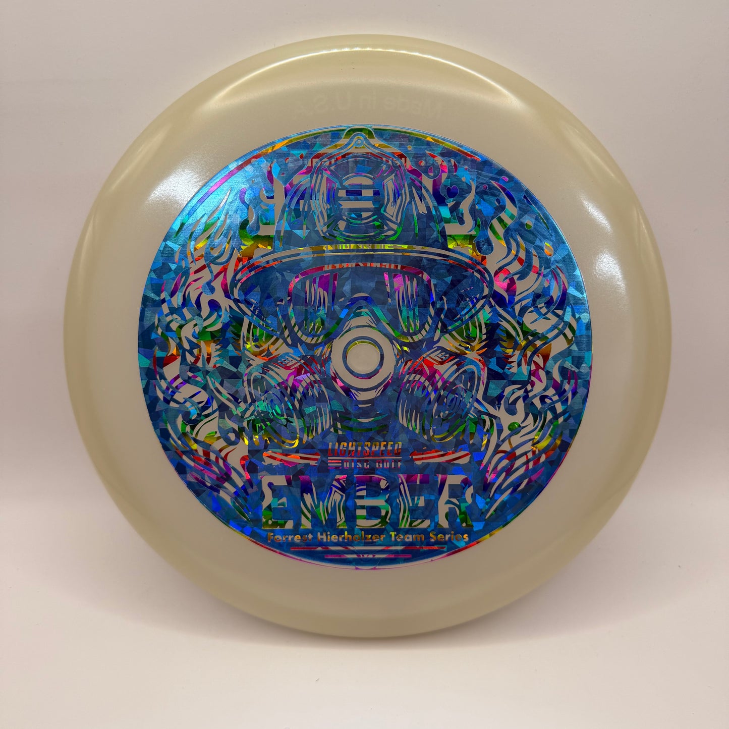 Lightspeed Ember Forrest Hierholzer Team Series putter featuring blue foil over rainbow foil firefighter-themed stamp on glow plastic.